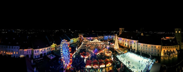 Aerial drone wide view of The Big Square in Sibiu at night Romania Old city centre decorated