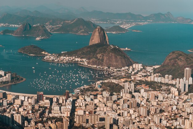 브라질의 햇빛 아래 바다와 언덕으로 둘러싸인 리우데 자네이루의 항공 사진