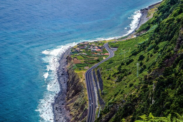 Aerial photography shot of a highway in the mountains on the shore of Madeira