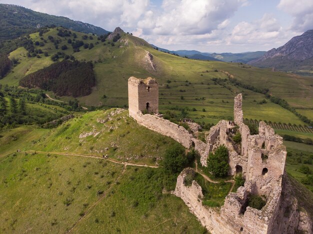 Aerial shot of an amazing medieval fortress on top of a hill in Rimetea, Transylvania, Romania