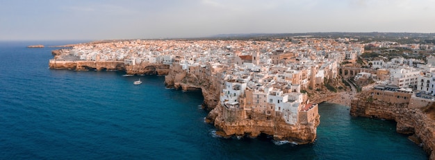 Aerial shot of an ancient city with old building and houses on the top of rocky hills