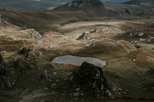 Aerial shot of beautiful brown hills during a misty weather