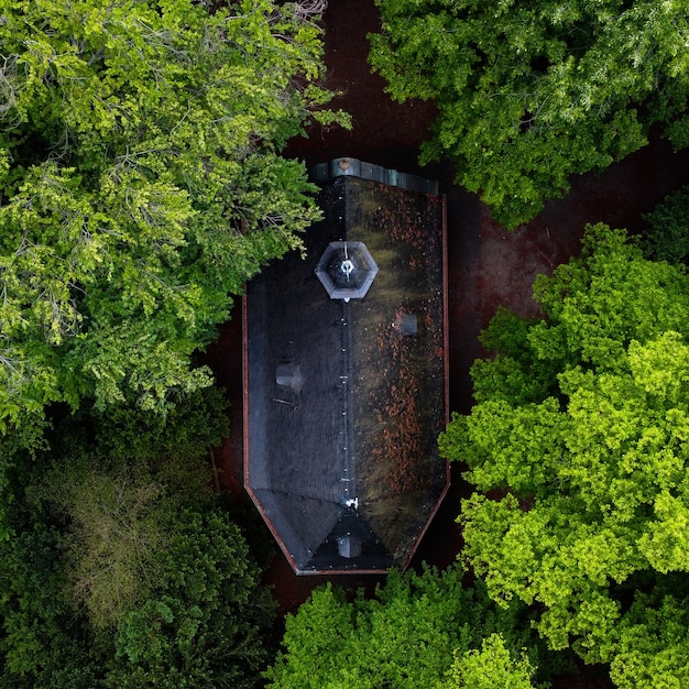 Aerial shot of a big residential house surrounded with green trees