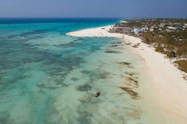 Aerial shot of coastline boats and seabed in Zanzibar Island Tanzania Africa