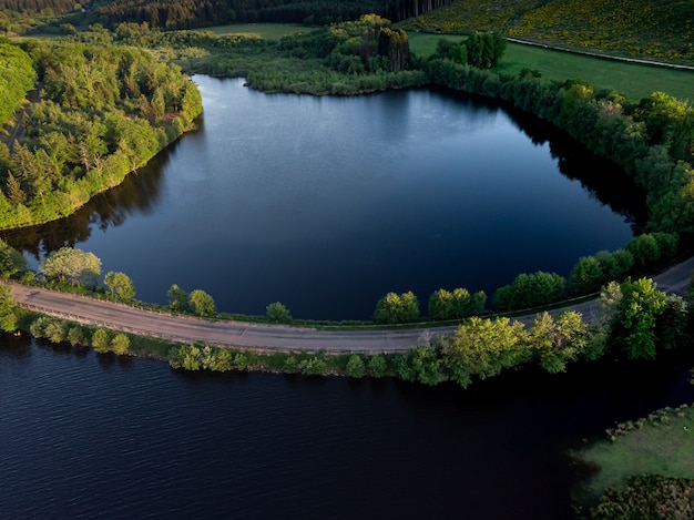 An aerial shot of an empty road over the river