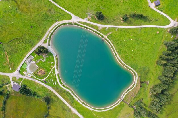 Aerial shot of the Filzalmsee surrounded by greenery in Austria