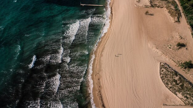 砂浜の海岸と緑の海の波の空中ショット