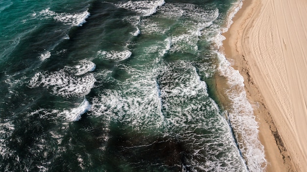 Воздушный выстрел из зеленых океанских волн с песчаным побережьем