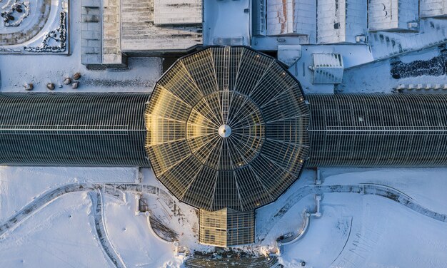 Aerial shot of a historical building with a dome in a snowy area