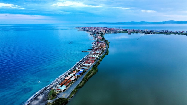 Ripresa aerea di case sulla riva stretta in mezzo al mare