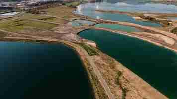 Free photo aerial shot of a landscape surrounded by mountains and lakes with industrial disaster