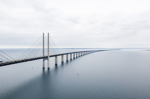 Aerial shot of a long self-anchored suspension bridge through sea