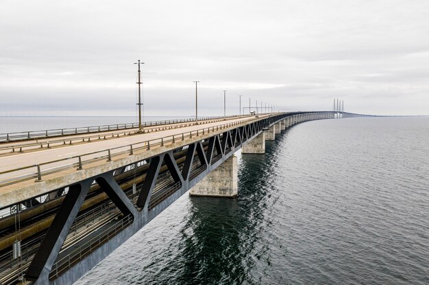Aerial shot of a long self-anchored suspension bridge through the sea