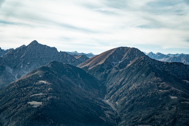 Aerial shot of mountains under cloudy sky