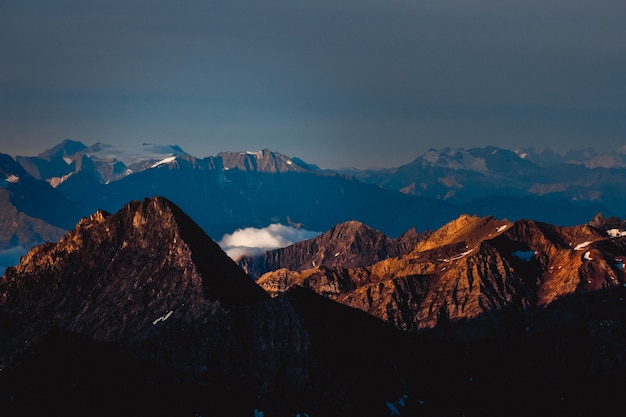 Aerial shot of mountains with a dark blue sky