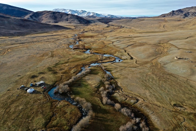 Free photo aerial shot of a river in a big dry grassland