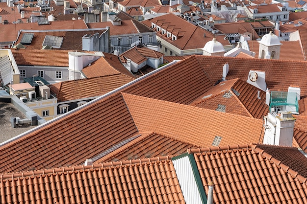 Aerial shot of rooftops of city buildings with red shingles