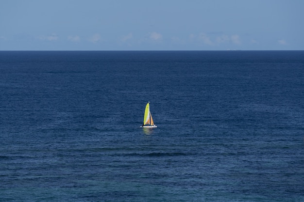 Aerial shot of a sailing boat in the sea