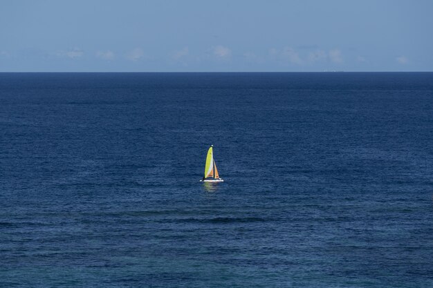 Aerial shot of a sailing boat in the sea