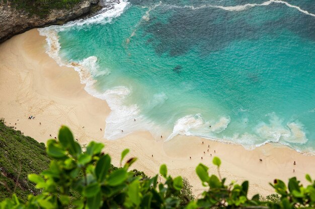 Aerial shot of sea waves at the seashore during daytime