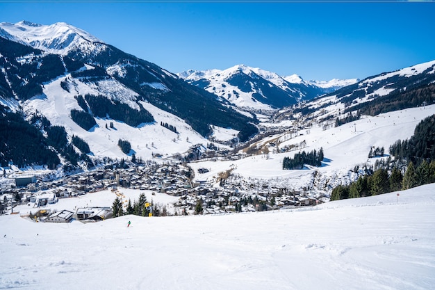 Aerial shot of a snowboarding resort in the snow under the sunlight