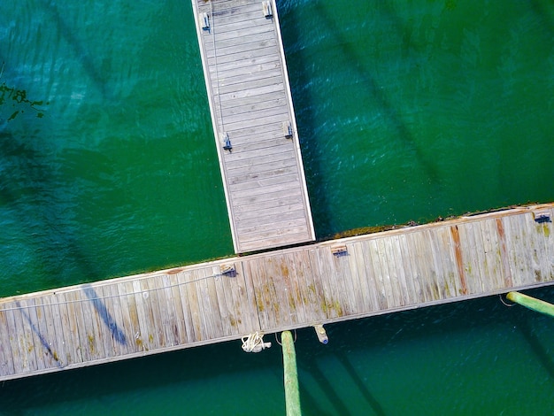 Aerial shot of a wooden pier with ropes on the dock