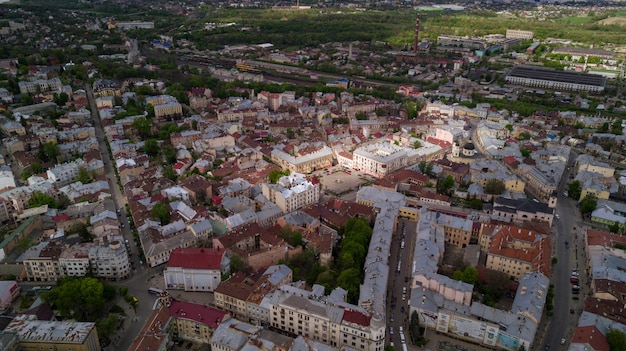 Aerial summer view of central part of beautiful ancient ukrainian city Chernivtsi with its streets, old residential buildings, town hall, churches etc. Beautiful town.