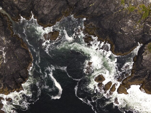 Aerial vertical shot of a sea with rocky mountains