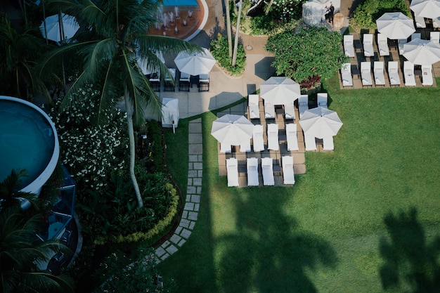 Aerial view of amazing porch with garden umbrella and loungers