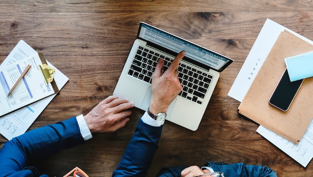 Free photo aerial view of businessman using computer laptop