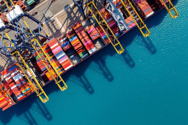 Aerial view of cargo ship and cargo container in harbor