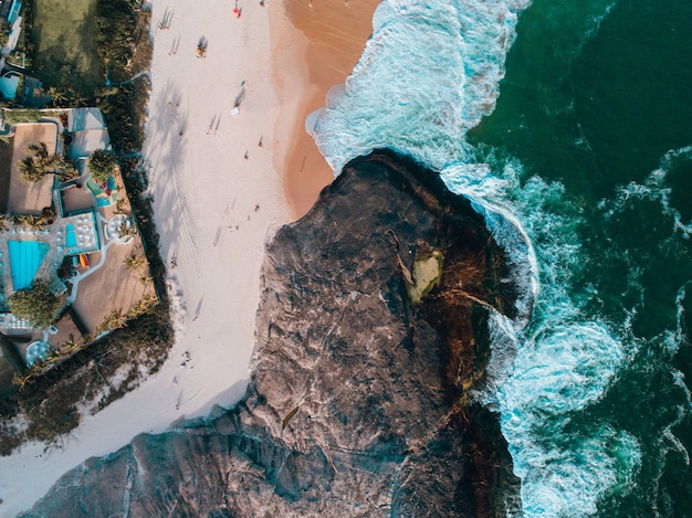 Aerial view of a cliff and the sandy beach in Brazil