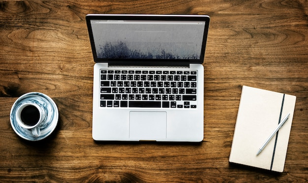 Aerial view of computer laptop on wooden table workspace concept