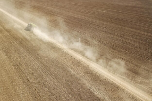 Aerial View Dirt road crossing Plowed Field