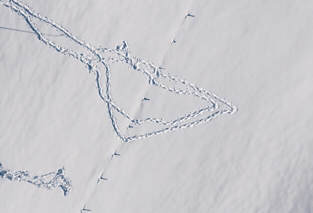 Aerial view of the footprints on the snow in winter