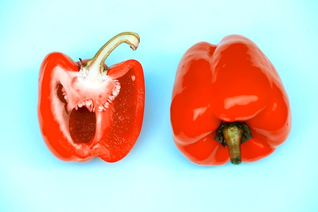 Aerial view of fresh sweet peppers on blue background