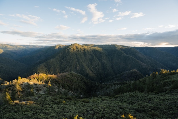 Aerial view of a green mountainous scenery during sunrise