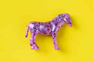 Free photo aerial view of horse figurine toy in a colorful background