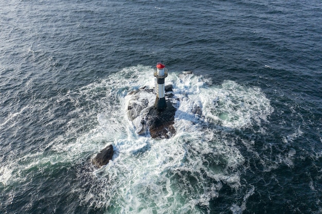 Aerial view of a lighthouse in the middle of the sea