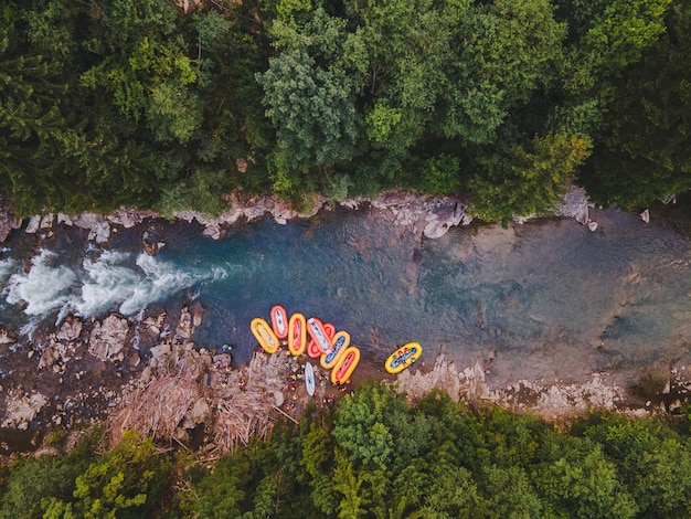 Aerial view of mountain river people rafting in creek. extreme vitality
