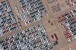 Free photo aerial view of new cars at parking port in automobile factory.