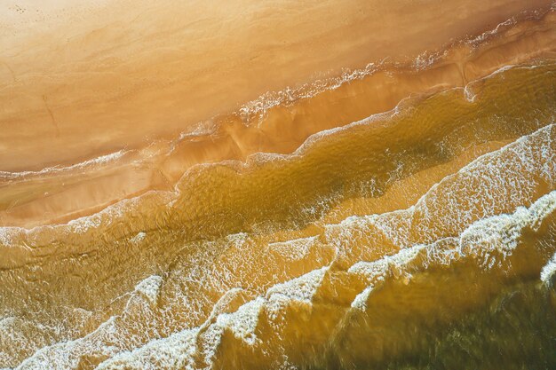 Aerial view of the ocean wave reaching the coastline