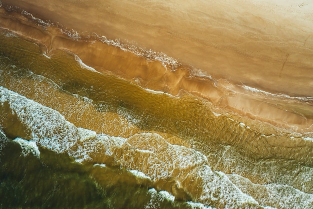 Aerial view of the ocean wave reaching the coastline