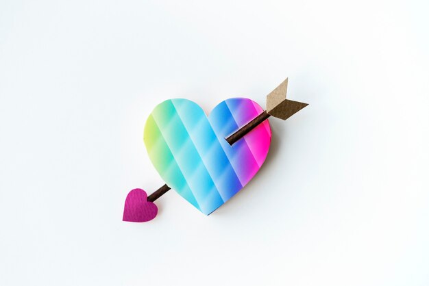Aerial view of paper craft heart with arrow on white background