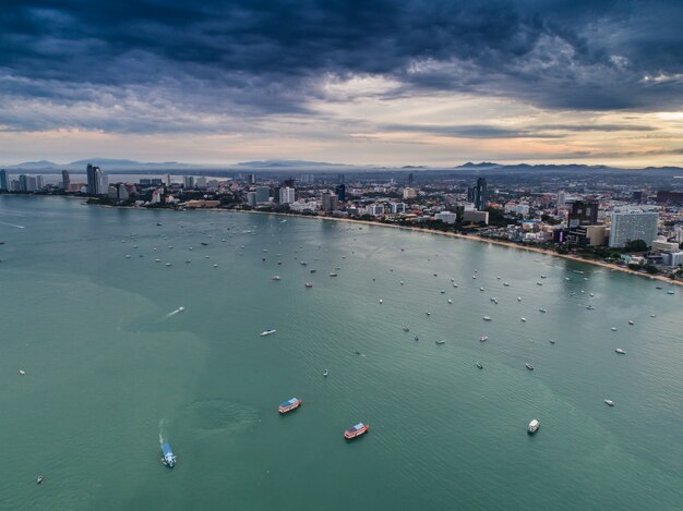 Aerial view of Pattaya beach as the sun rises over the ocean. Thailand.