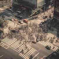 Free photo aerial view of people walking on crosswalk in the city