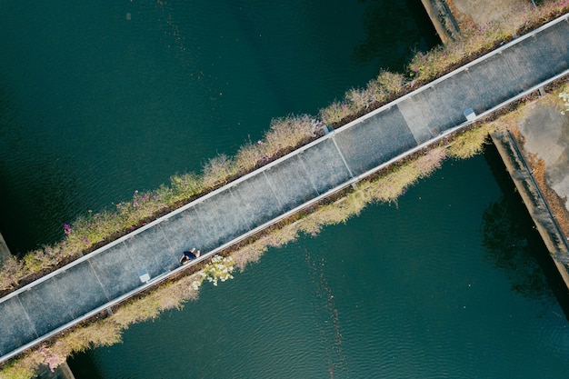 Aerial view of person walking through a bridge 