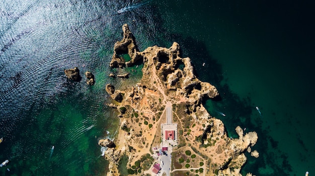 Aerial view of Ponta da Piedade of Lagos, Portugal. Beauty landscape of rugged seaside cliffs and aqua ocean waters in the Algarve region of Portugal