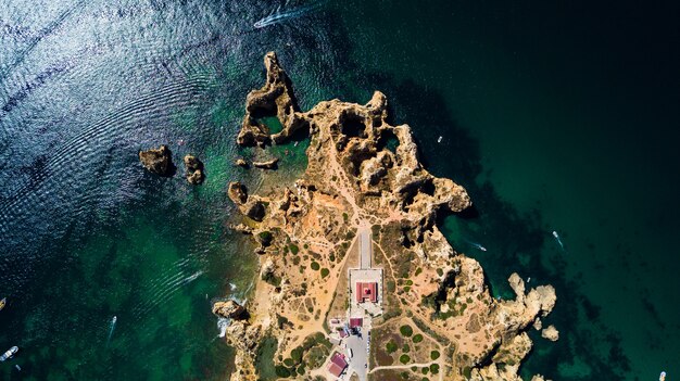 Aerial view of Ponta da Piedade of Lagos, Portugal. Beauty landscape of rugged seaside cliffs and aqua ocean waters in the Algarve region of Portugal