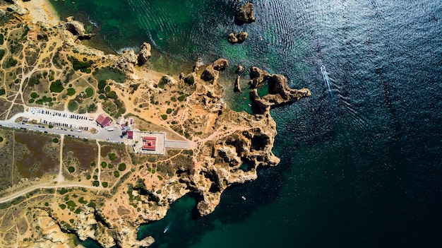 Aerial view of Ponta da Piedade of Lagos, Portugal. Beauty landscape of rugged seaside cliffs and aqua ocean waters in the Algarve region of Portugal